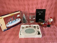Full view of the Lemax 'After School Hockey' diorama with main ice rink, children hockey players, streetlamp, and Christmas decor including Santa and toy truck.