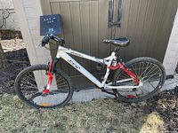 Side view of used Vandal CCM mountain bike showing frame design, dual suspension, and tires.