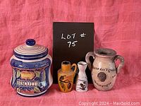 Front view of all four items arranged in a row showing the biscotti jar, beige vase, yellow oil jar, and white vinegar jar.