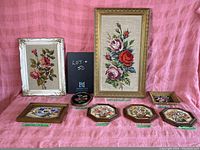 All eight framed floral embroidery pieces displayed on pink fabric.