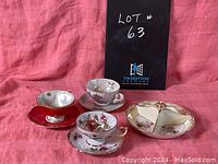 All items displayed together showing a set of three vintage cups and saucers plus a sectioned serving plate with delicate designs.