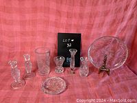 Full view of all crystal items on pink fabric background with serving tray on stand