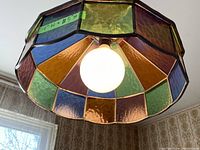 Close-up view of the rainbow stained glass light fixture's interior and single bulb