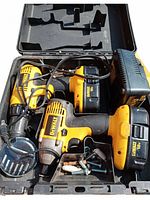 Open DeWalt case containing cordless drill, impact driver, batteries, charger and bits