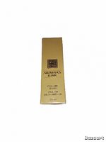 Sealed yellow box of Aromatics Elixir perfume with gold branding seen from front side