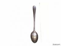 Single sterling silver spoon with a rounded bowl and plain handle shown front on against white background.