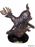 Front and angled view of bronze colored resin elk or deer statue with antlers leaping over broken fence on black base with plaque.