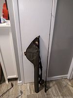 Full view of Mitchell fishing rod alongside the Plano carrying case, showing length and condition.