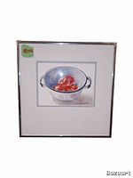 Framed watercolor painting depicting a silver colander filled with tomatoes, signed Nancy Woodall 1992, with a price sticker.