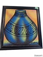 Front view of the framed original South African sand painting showing the colorful pot with geometric patterns and artist signature.