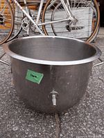 Stainless steel 12 quart bowl showing side handles and drainage spout at bottom.