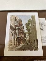 Print showing a narrow street with old buildings and balconies in New Orleans, by Don Davey