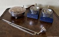 Photo showing the full set with silver sugar bowl, two miniature silver baskets in boxes, and a long silver spoon with wooden handle.