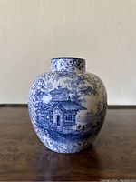 Front view showing architectural and pastoral landscape design on the vase.