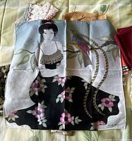Scarf depicting an Asian woman sitting among branches and flowers with a colorful bird, predominantly black, pink, white and beige.