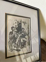 Framed vintage etching of two men playing a violin and a woodwind instrument, black and white.