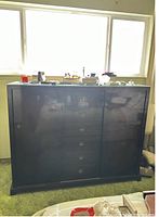 Front view showing entire dresser with 8 drawers in center and 2 side cabinets closed