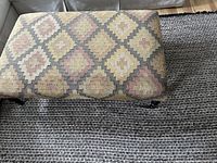 Top view of the large ottoman showing the Kilim fabric pattern with geometric diamond shapes in soft colors.