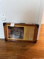 Photo of the unopened wooden carrying case packaging showing the lot contents and label