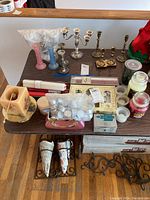 Overview of assorted candles, candleholders, and tealight gift set including Yankee candles, pillar candle, and various holders.