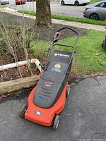 Lawn Hog BD electric mulching mower in orange and black with a front view showing the handle and body.
