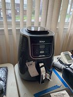 Front view of the black Ninja XL Air Fryer multi machine showing control panel and handle