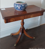 Table folded, top surface view with decorative bowl to show folded configuration and surface condition