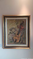 Full frontal image of the framed oil painting showing the entire artwork depicting a violin, scale, and vase.