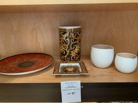 Shelf with all four items: Rosenthal Versace Barocco vase, Medusa plate, and modern ceramic milk jug and creamer