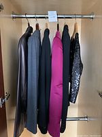Rack view showing six hanging blazers in various colors and materials
