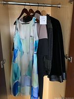 All garments hung on wardrobe rail showing full assortment