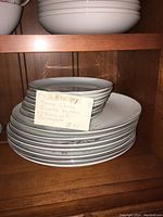 Stack of plates and bowls showing sizes and shapes of the dinnerware.