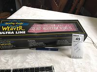 Photo showing the Weaver Ultra Line model car box with 1/48 scale and features text, pen for size comparison, and a MaxSold tag.