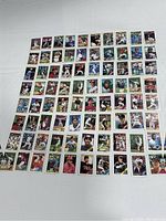 Top down view of 80 O-Pee-Chee 1988 baseball cards arranged in neat rows on white cloth background.