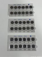 Three sets of 12 Canadian quarters each, in plastic holders, labeled by month for 125 years Confederation