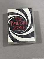 Front cover of The Twilight Zone complete series DVD boxed set showing title and spiral design.
