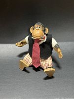 Front view of the vintage Russ Berrie smoking gorilla figure sitting against a black background.