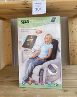 Original packaging box showing the SPA massage cushion box with branding and features, including heat function and remote control.