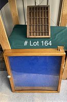 Display case and printer's block tray side by side, showing size difference and condition.