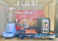 Photo showing all three appliances together: Starfrit griddle in original box, Black & Decker toaster, Sunbeam blender.
