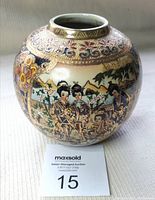 Front view of round Satsuma vase showing colorful Geisha figures and detailed gold border patterns near the rim.