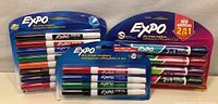 Three sealed packs of Expo dry erase markers including an 8-pack, 4-pack low odor, and 5-pack 2-in-1 color markers.