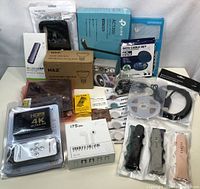 Full lot of assorted new electronic items and accessories taken together showing packaging and variety.