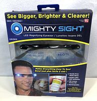 Photo of new in box Mighty Sight LED magnifying eyewear with packaging showing features such as 160% magnification, bright LEDs, HD lenses, rechargeable, and hands-free use.