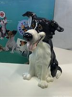 Front view of Glen dog figurine with box showing Pets with Personality logo and designs.