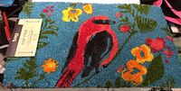 Front view of multicolor coir mat with bird and floral patterns on blue background