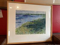 Full view of the framed watercolour painting showing the river, vegetation and sky in impressionistic style.