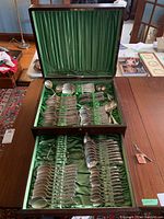 Wooden case open, two trays showing assorted cutlery