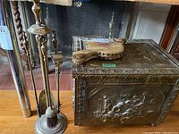 Photo showing fireplace tools with stand and metal lined wood box with embossed decorative side panel
