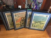 Photo showing six framed Star Weekly magazine covers with WWII aviation themes.